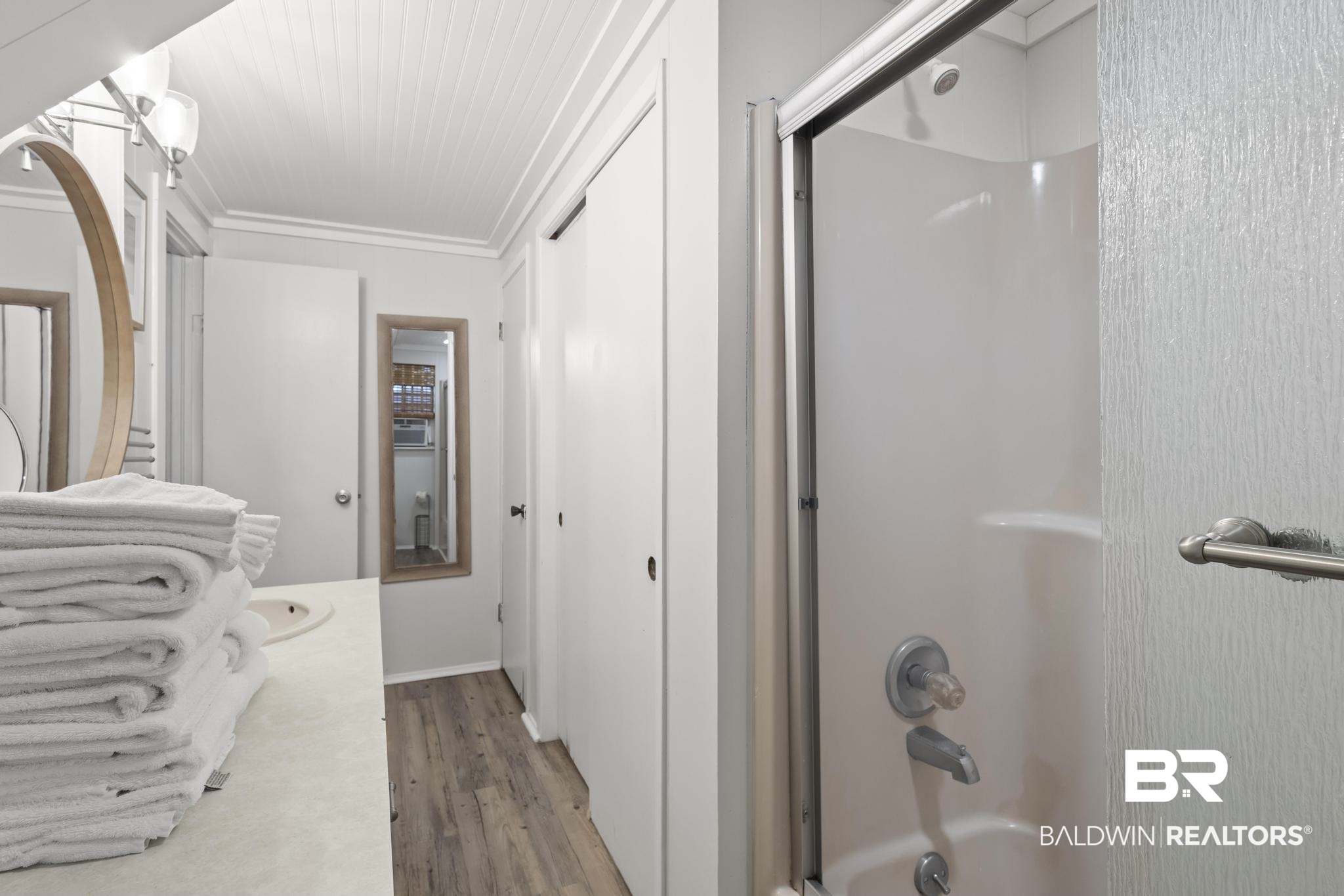 562 Veterans Road Gulf Shores, AL 36542 - Photo 21 of 32 Full bath with wood finished floors, ornamental molding, and washtub / shower combination