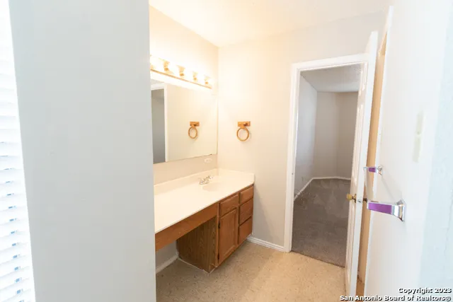 a bathroom with a double vanity sink and mirror