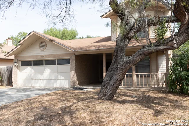 a house that has a tree in front of the house