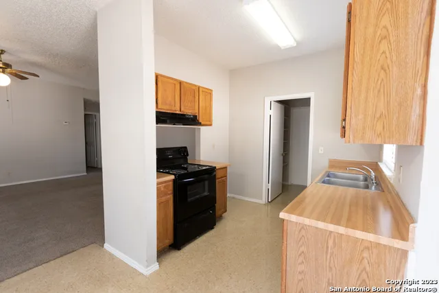 a kitchen with a stove and a refrigerator