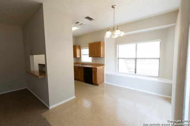 a view of a kitchen with a stove cabinets and a windows