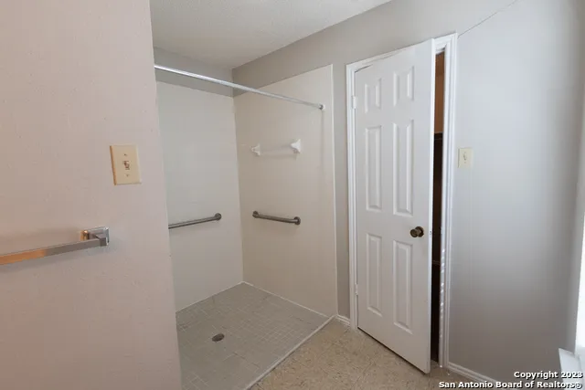 a bathroom with a glass shower door