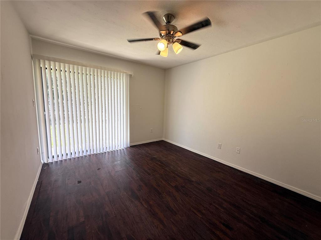 421 Southwest 67th Terrace, Unit A Gainesville, FL 32607 - Photo 11 of 13 wooden floor in an empty room with a window