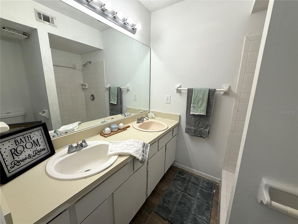 421 Southwest 67th Terrace, Unit A Gainesville, FL 32607 - Photo 12 of 13 a bathroom with a sink and a mirror
