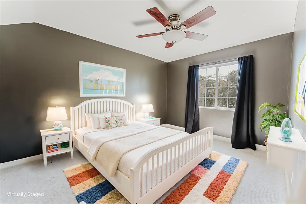 2935 Aein Road Orlando, FL 32817 - Photo 14 of 27 a bedroom with a bed and a chandelier