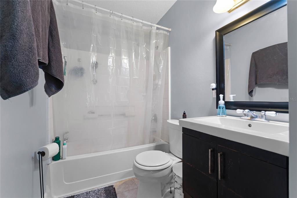 2935 Aein Road Orlando, FL 32817 - Photo 16 of 27 a bathroom with a sink a toilet and a mirror