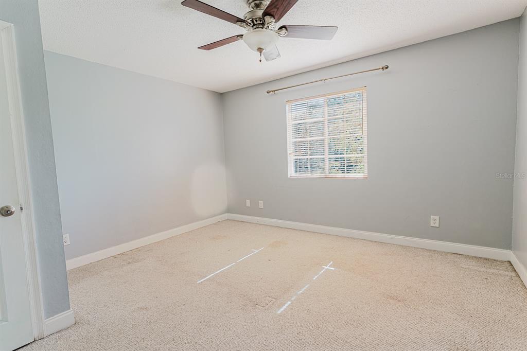 2935 Aein Road Orlando, FL 32817 - Photo 18 of 27 an empty room with a window and a fan