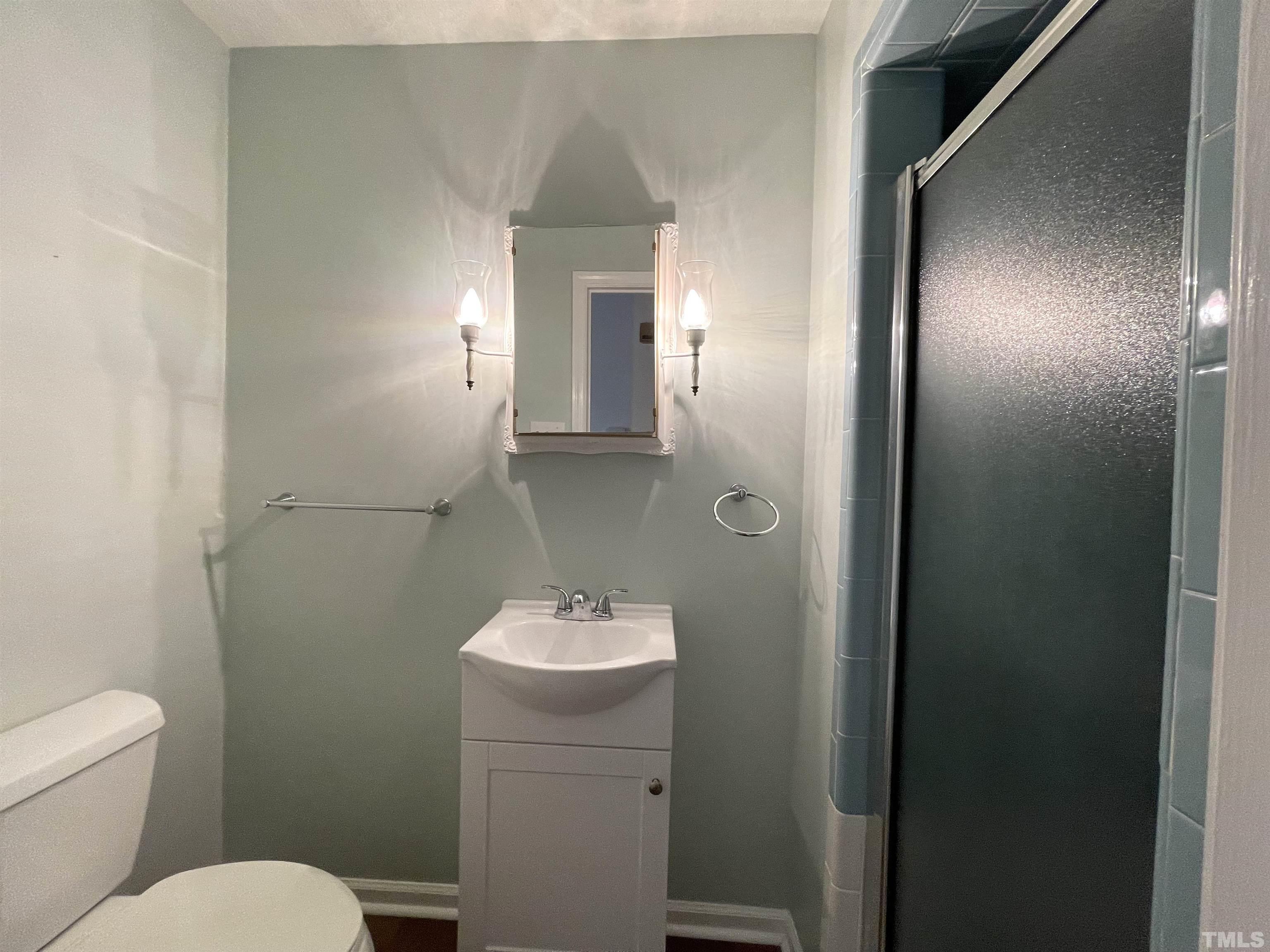 2995 Government Road Clayton, NC 27520 - Photo 11 of 15 a bathroom with a toilet a sink and mirror