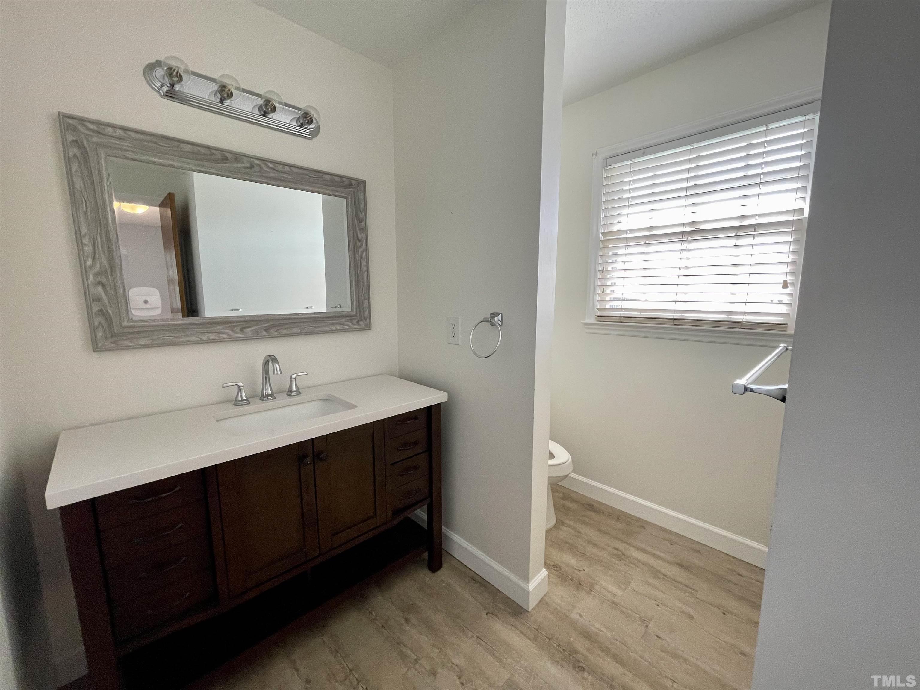 2995 Government Road Clayton, NC 27520 - Photo 13 of 15 a bathroom with a toilet sink and mirror