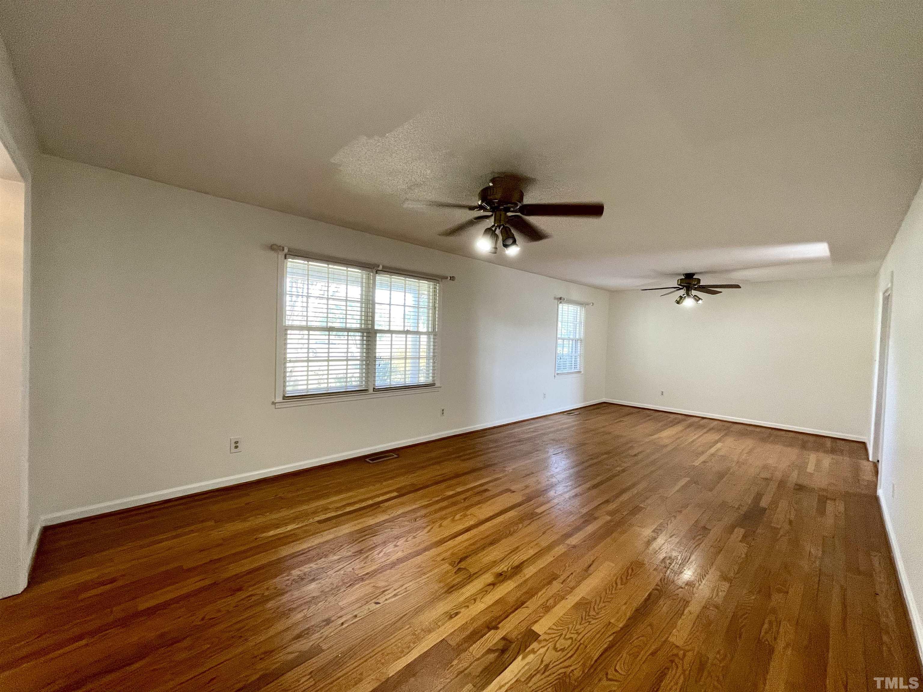 2995 Government Road Clayton, NC 27520 - Photo 3 of 15 a view of empty room with wooden floor and fan