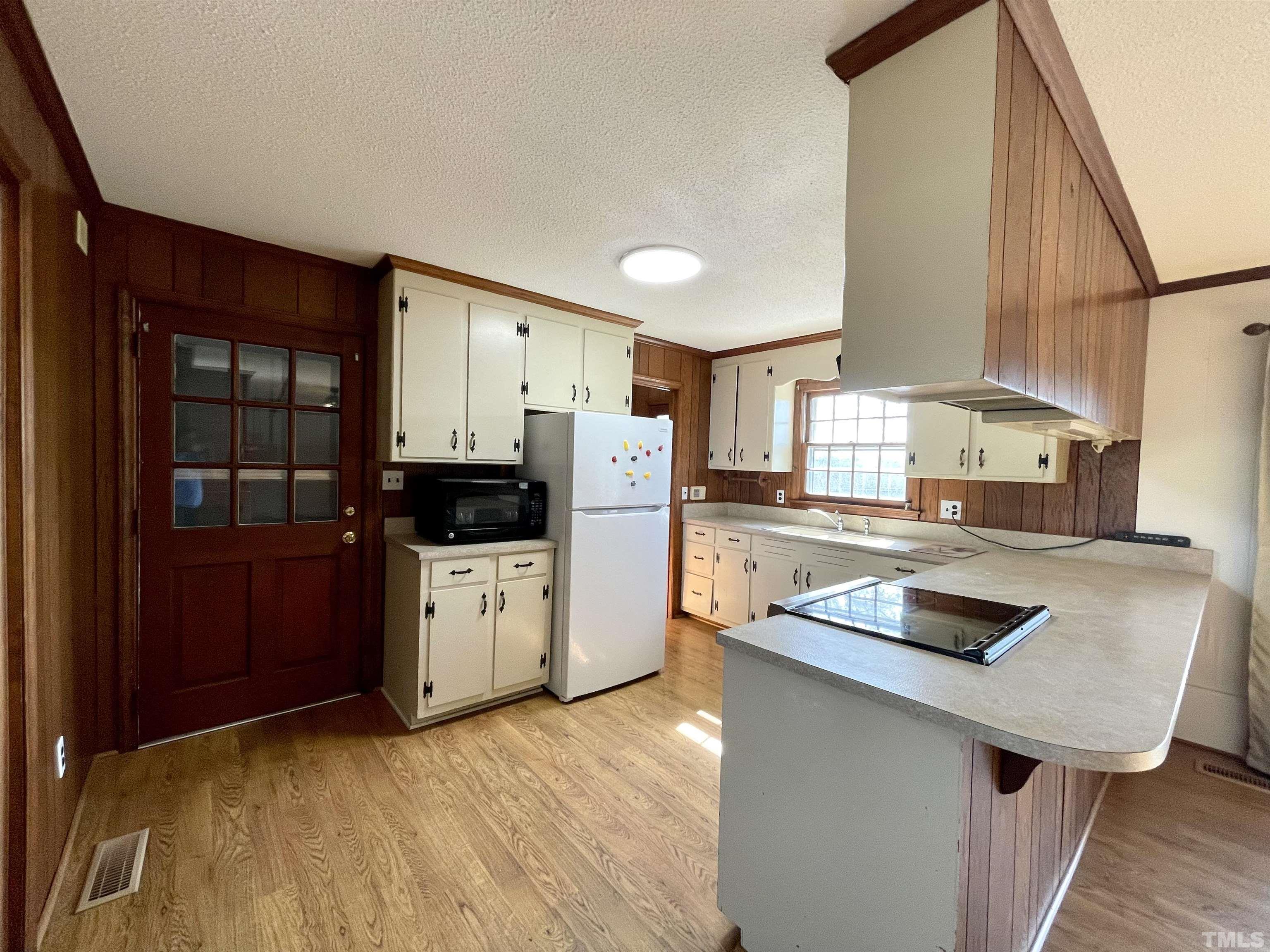 2995 Government Road Clayton, NC 27520 - Photo 5 of 15 a kitchen with stainless steel appliances granite countertop a refrigerator a stove and a sink