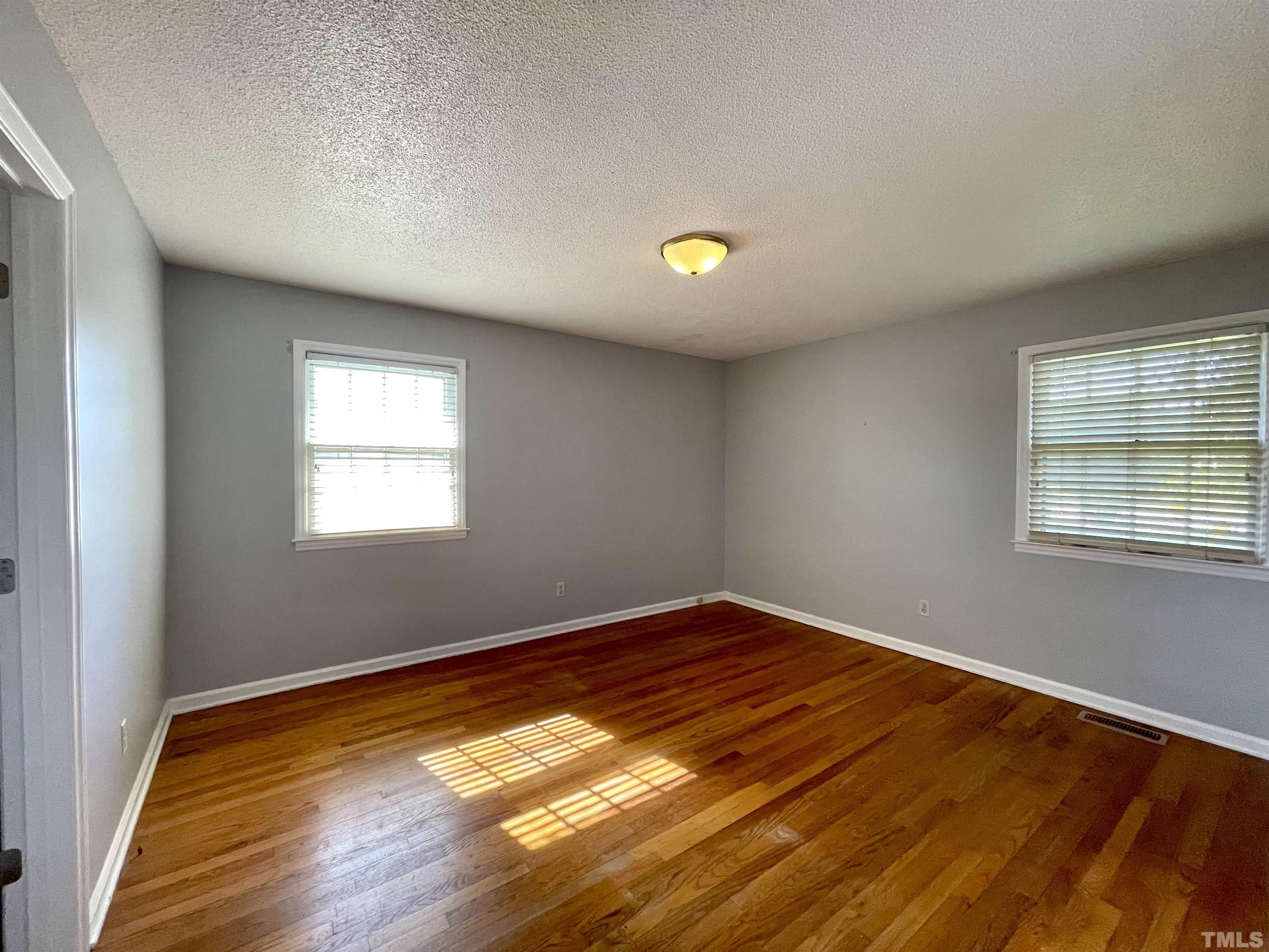 2995 Government Road Clayton, NC 27520 - Photo 9 of 15 a view of empty room with wooden floor and fan