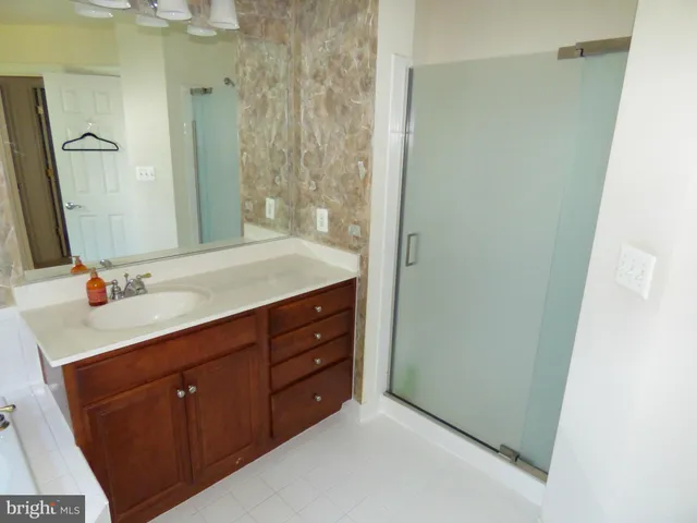 a bathroom with a double vanity sink and mirror