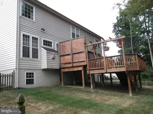 a small white house with a table and chairs