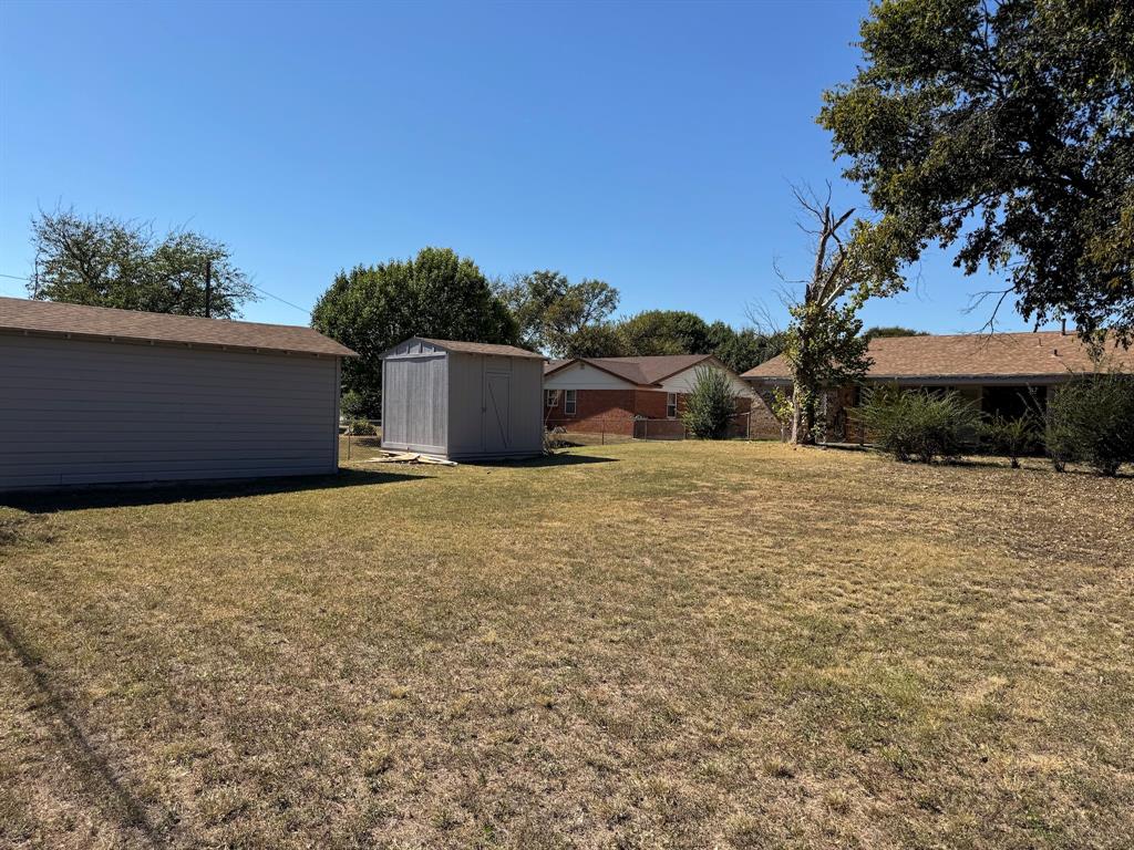 1413 Phillips Street Cleburne, TX 76033 - Photo 12 of 14 a backyard of a house with lots of green space
