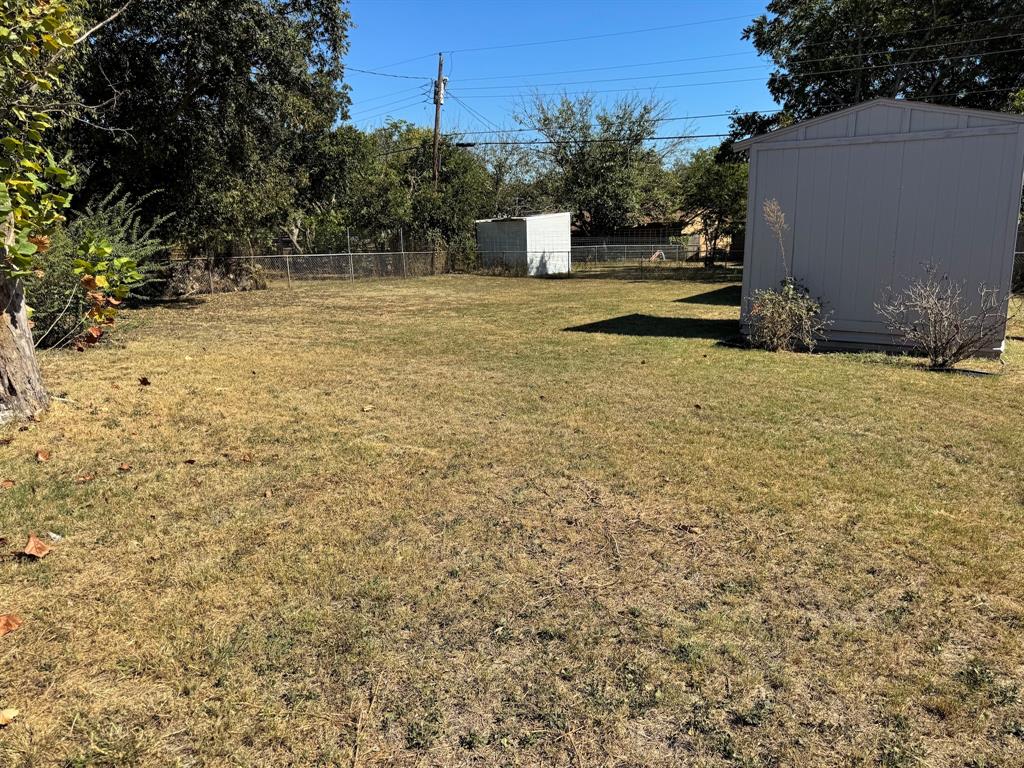1413 Phillips Street Cleburne, TX 76033 - Photo 14 of 14 a view of a yard with trees