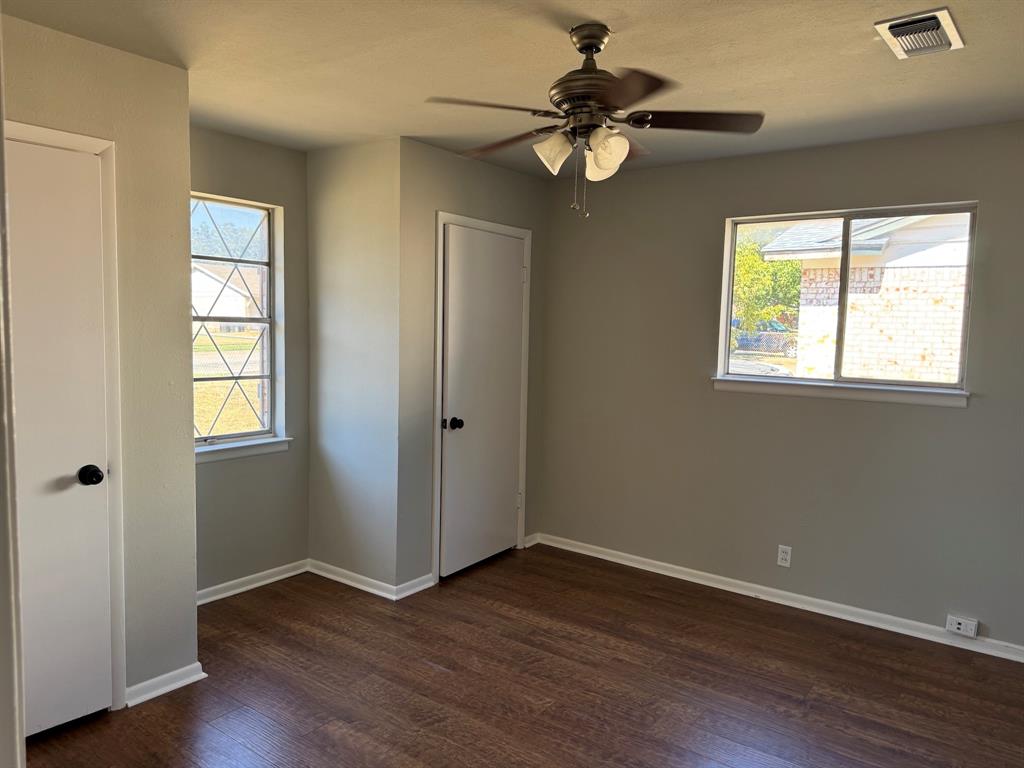 1413 Phillips Street Cleburne, TX 76033 - Photo 2 of 14 a view of an empty room with wooden floor and a window