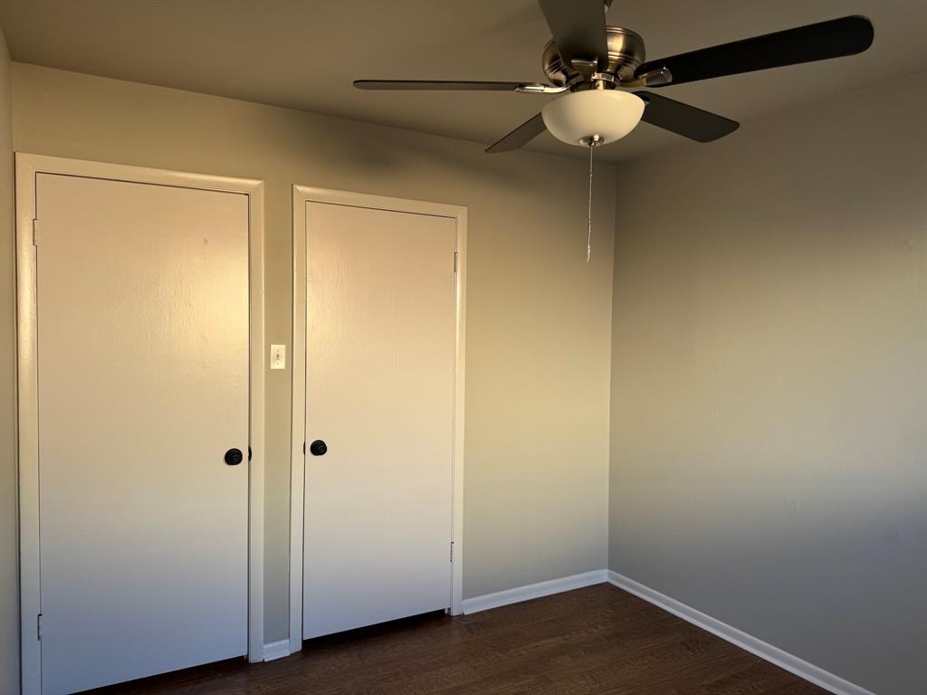 1413 Phillips Street Cleburne, TX 76033 - Photo 3 of 14 a view of an empty room with wooden floor