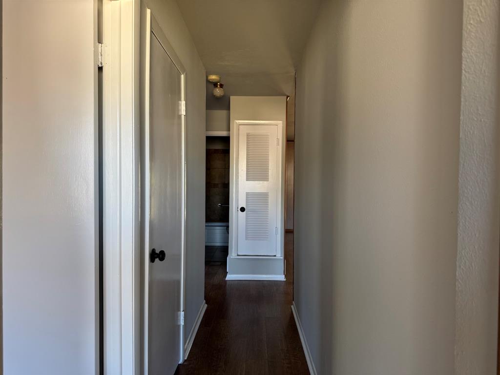1413 Phillips Street Cleburne, TX 76033 - Photo 7 of 14 a view of a hallway with wooden floor