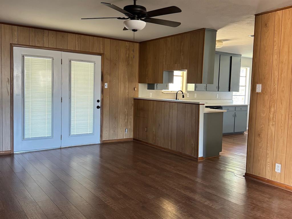 1413 Phillips Street Cleburne, TX 76033 - Photo 8 of 14 a view of a kitchen with a sink dishwasher and wooden floor