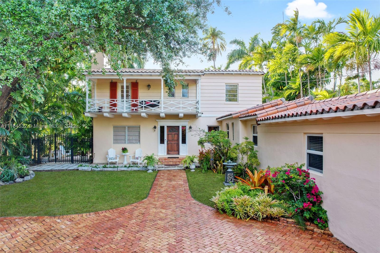 a front view of a house with a garden and plants