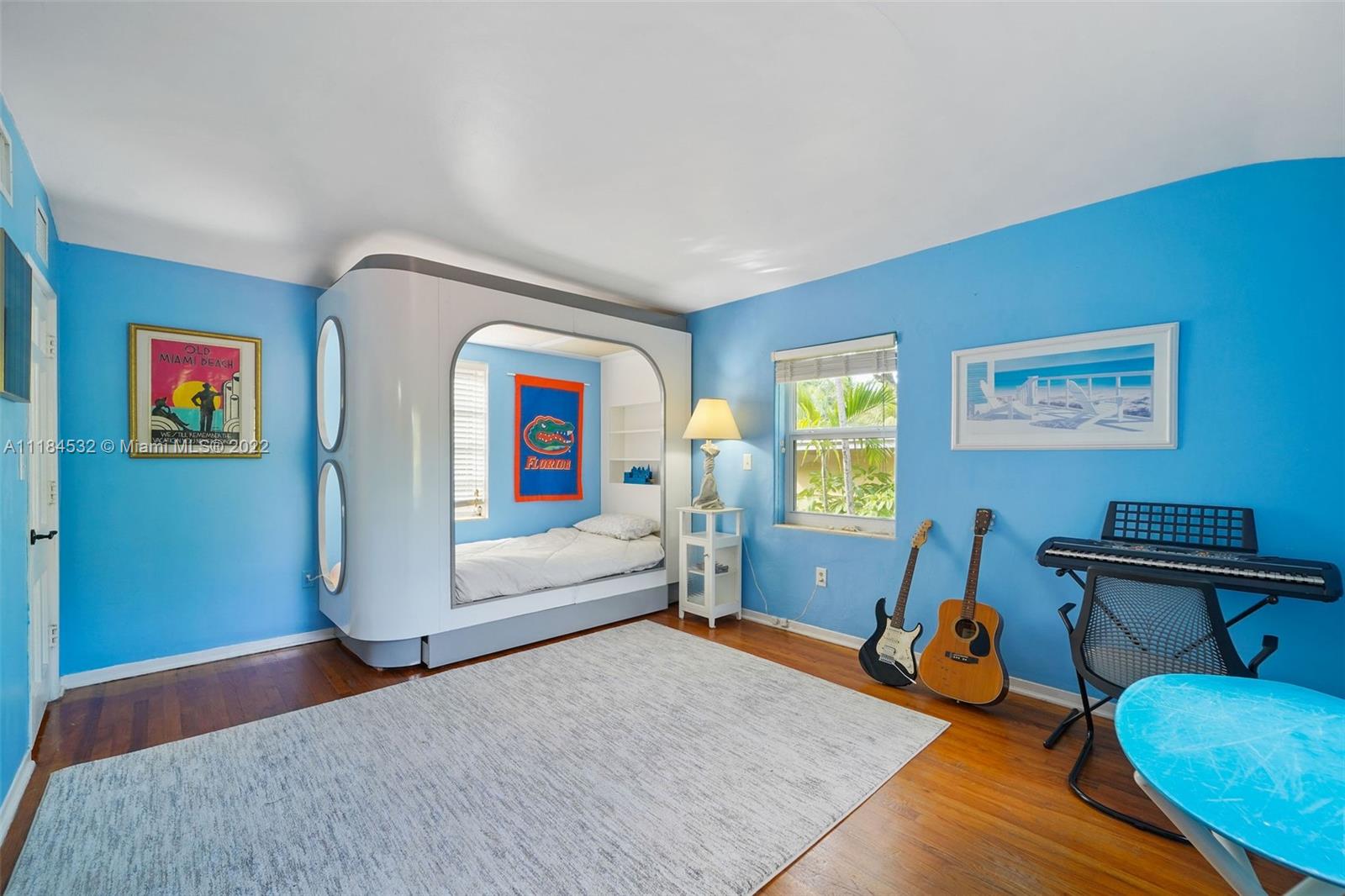 5842 Alton Road Miami Beach, FL 33140 - Photo 14 of 36 a bedroom with furniture and a window