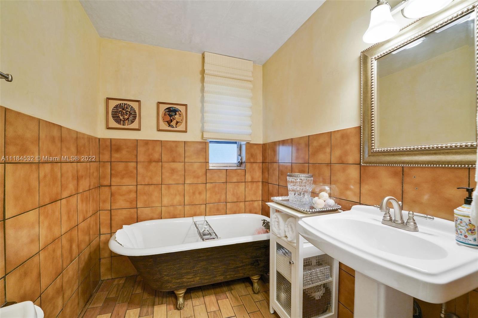 5842 Alton Road Miami Beach, FL 33140 - Photo 15 of 36 a bathroom with a sink and a bathtub