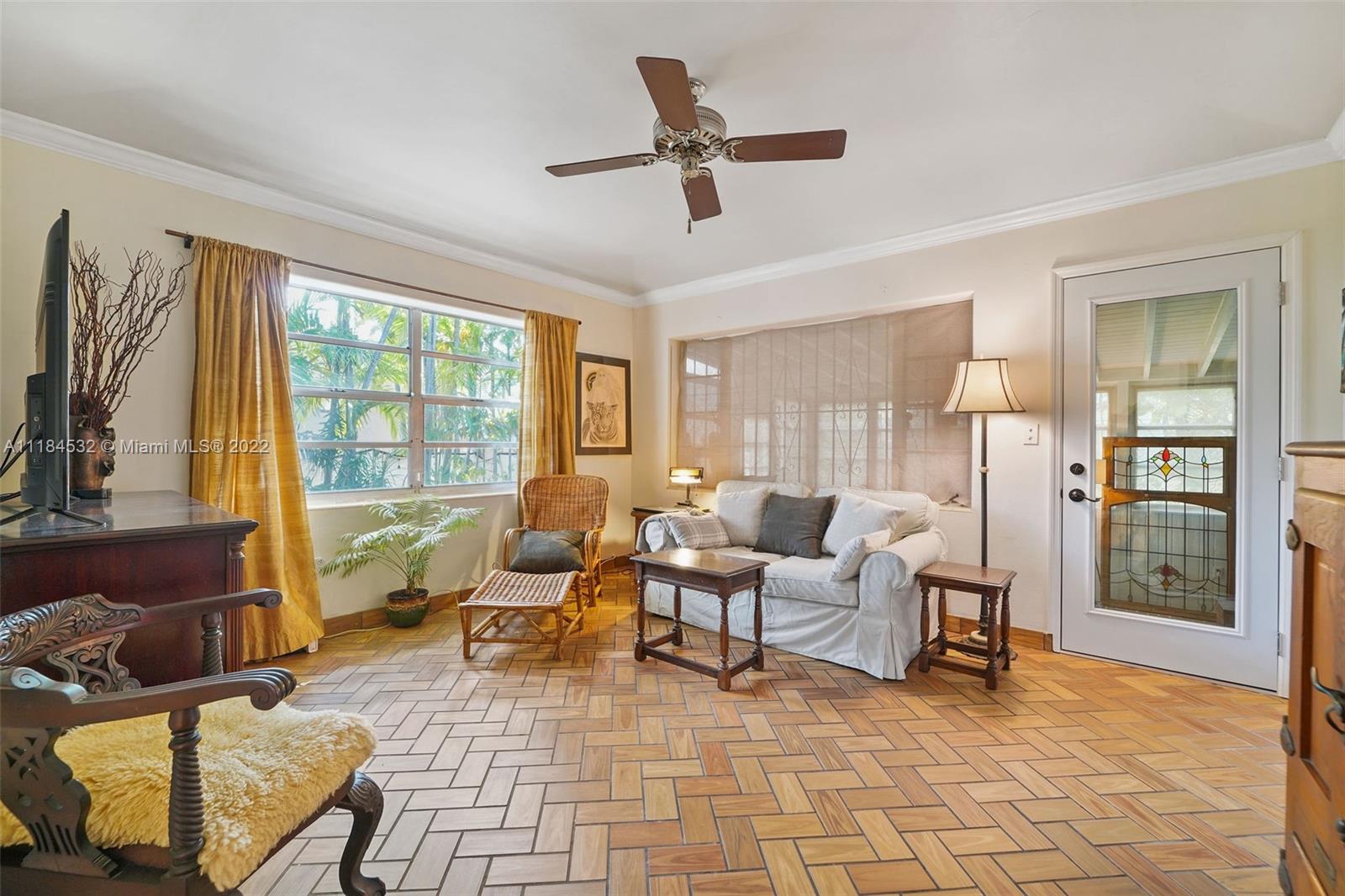 5842 Alton Road Miami Beach, FL 33140 - Photo 19 of 36 a living room with furniture and a large window