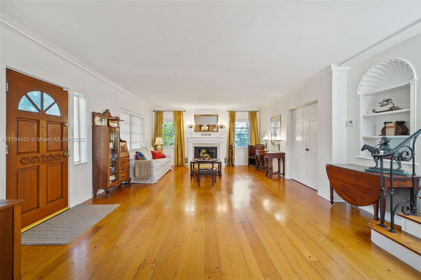 5842 Alton Road Miami Beach, FL 33140 - Photo 2 of 36 a living room with furniture and a wooden floor