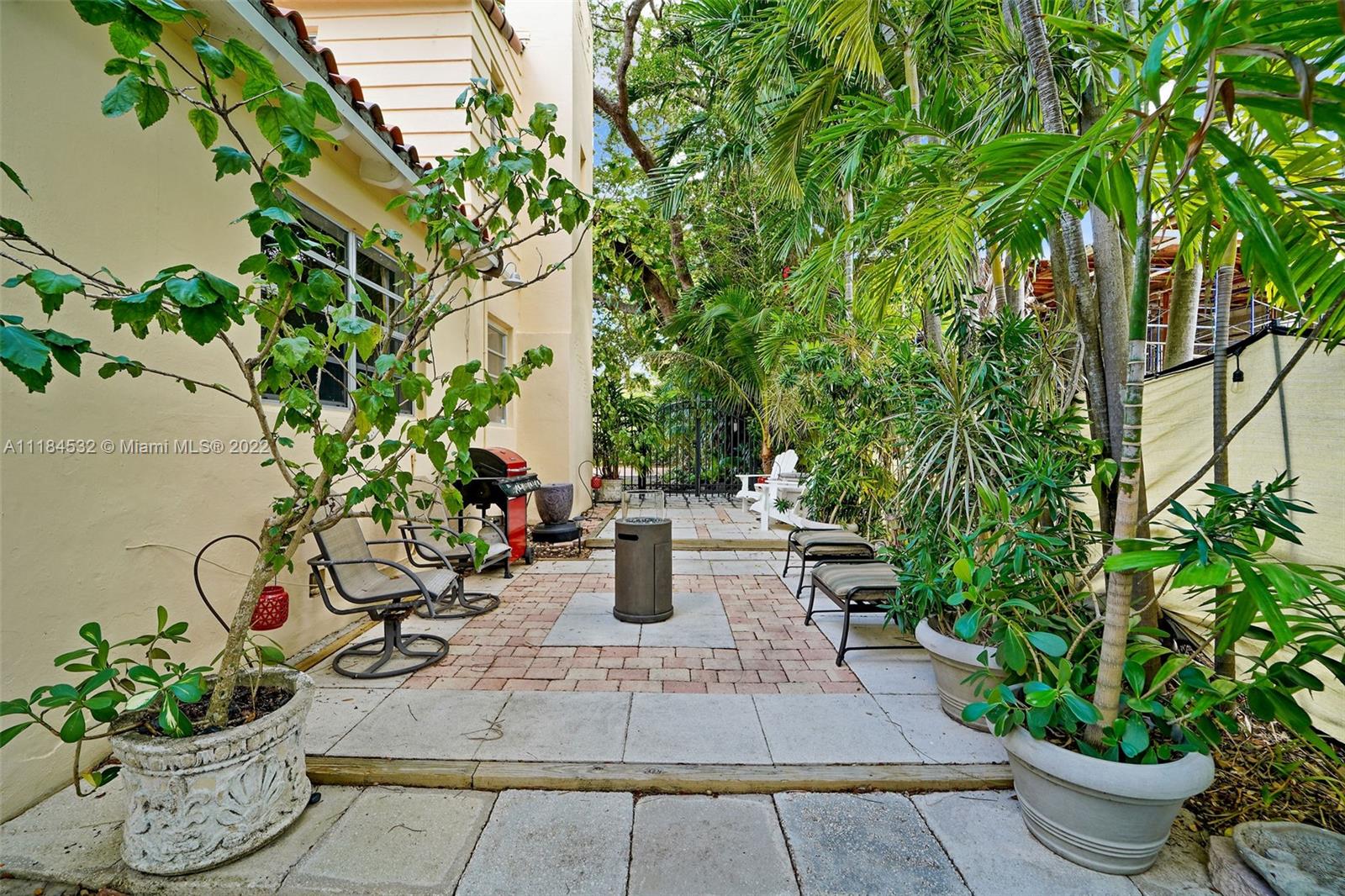 5842 Alton Road Miami Beach, FL 33140 - Photo 22 of 36 a view of a backyard with potted plants