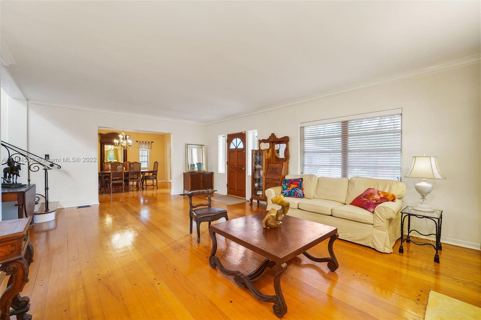 5842 Alton Road Miami Beach, FL 33140 - Photo 3 of 36 a living room with furniture and a table with wooden floor