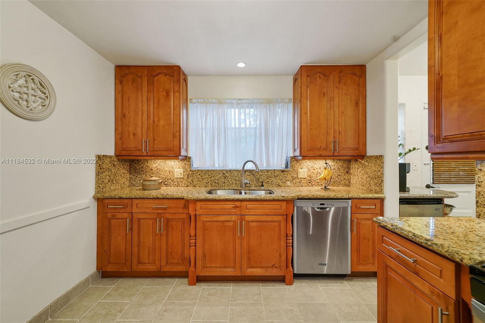 5842 Alton Road Miami Beach, FL 33140 - Photo 8 of 36 a kitchen with a sink and cabinets