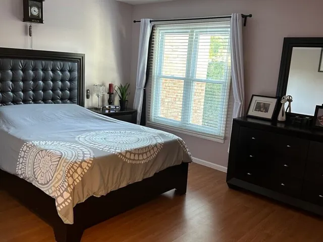 a bathroom with a granite countertop bathtub shower and toilet