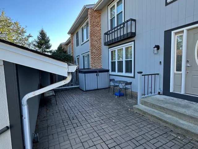 a view of backyard with deck and seating space