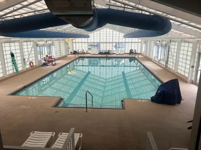 a room with pool table and windows