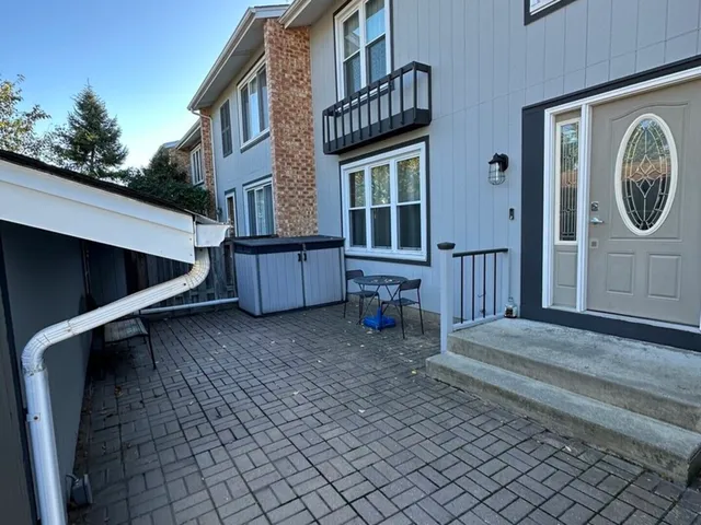 a view of a house with wooden fence