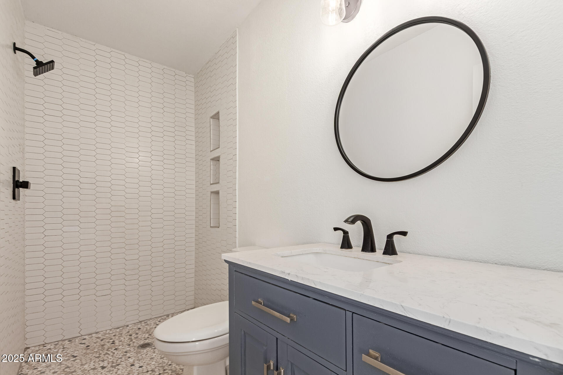 709 East Edison Avenue Buckeye, AZ 85326 - Photo 16 of 33 a bathroom with a sink a toilet and a mirror
