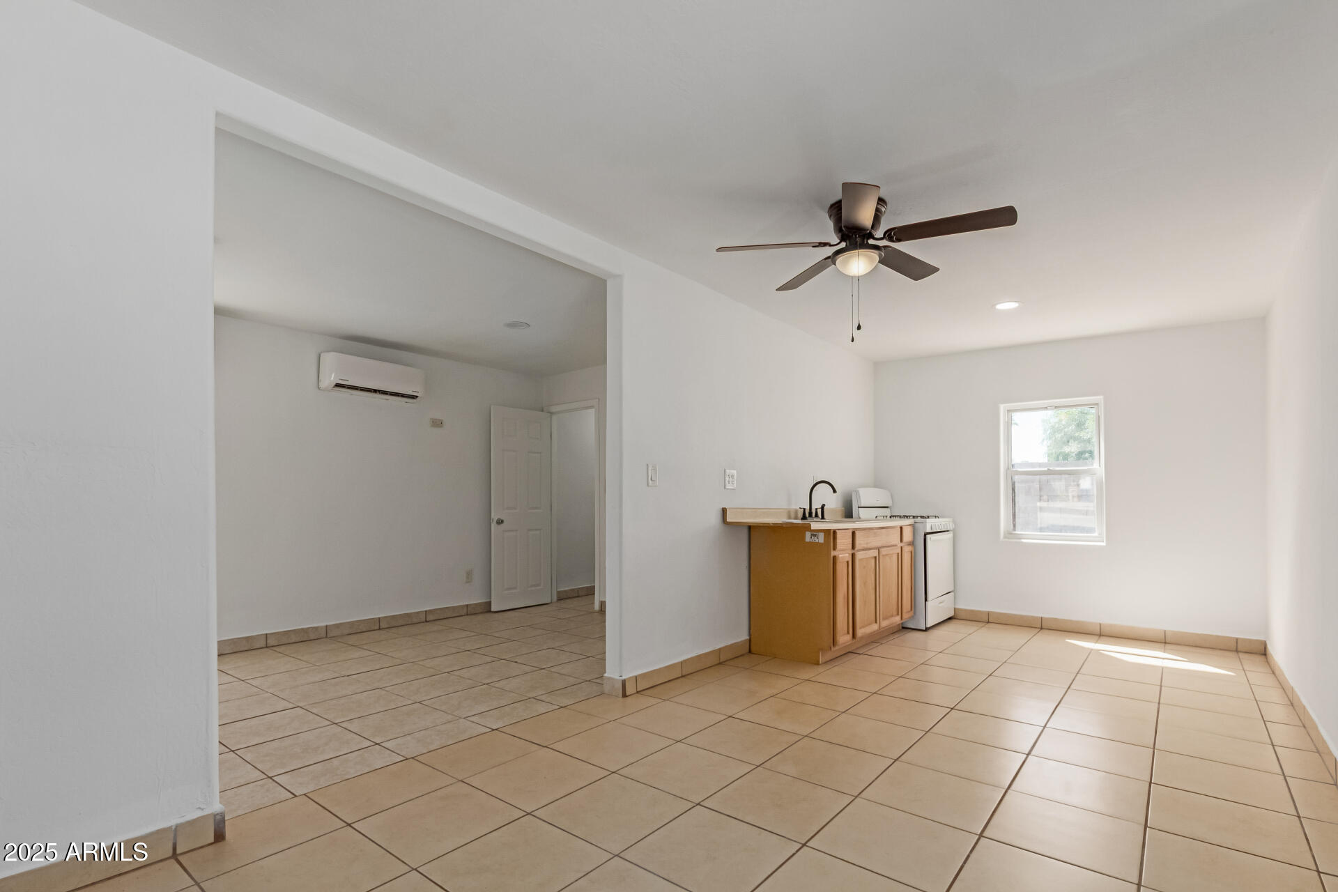 709 East Edison Avenue Buckeye, AZ 85326 - Photo 22 of 33 a view of a room with window and a ceiling fan