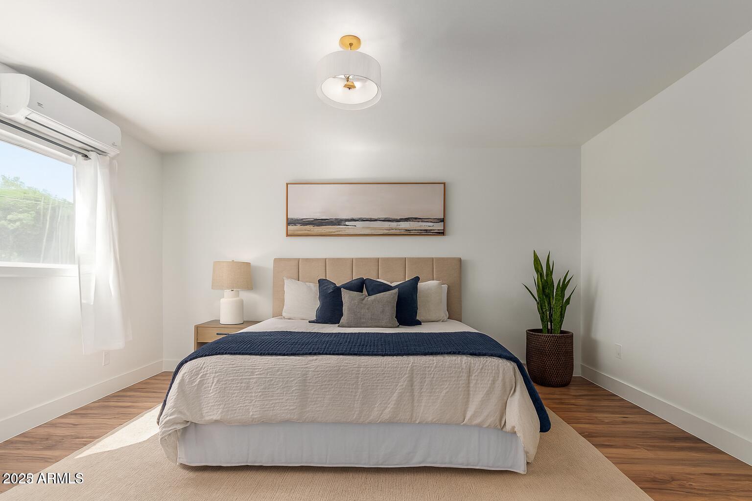 709 East Edison Avenue Buckeye, AZ 85326 - Photo 4 of 33 a bedroom with a bed and painting on the wall