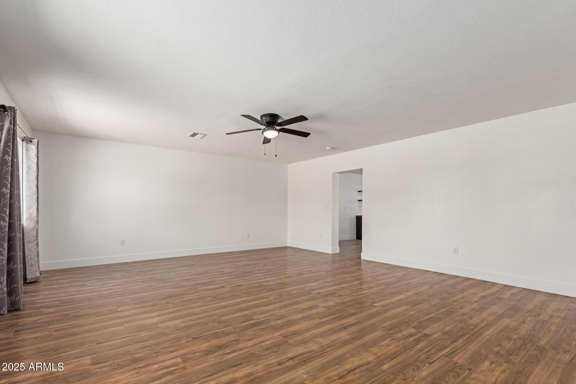 709 East Edison Avenue Buckeye, AZ 85326 - Photo 7 of 33 wooden floor in an empty room