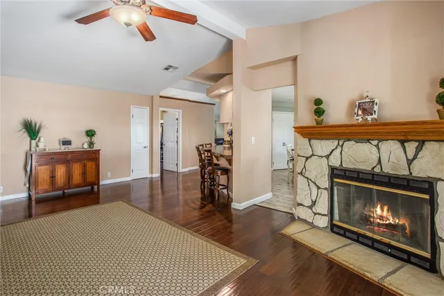 a kitchen with stainless steel appliances granite countertop a stove a refrigerator a kitchen island a table and chairs