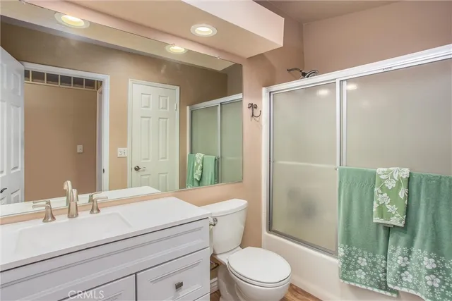 a bedroom with a bed and a dresser next to a window