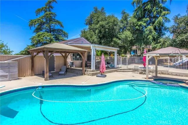 a view of a swimming pool with a yard
