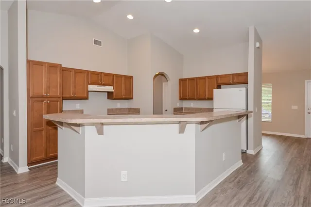 a kitchen with stainless steel appliances a sink and a refrigerator