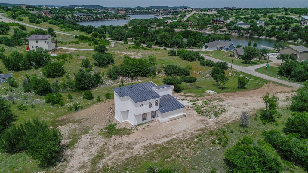 7108 Hells Gate Loop Strawn, TX 76475 - Photo 4 of 17 an aerial view of a house with a yard and lake view