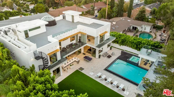 an aerial view of multiple houses with yard