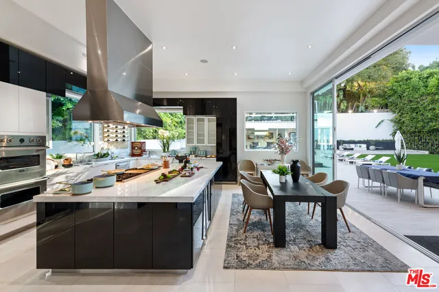a kitchen with a table chairs sink and cabinets