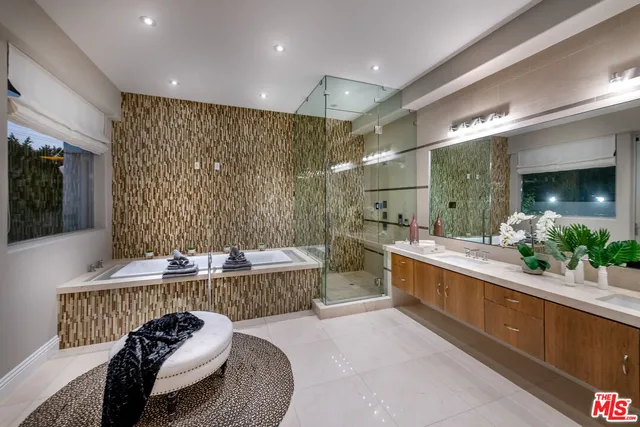 a hallway with a potted plant on the counter and mirror