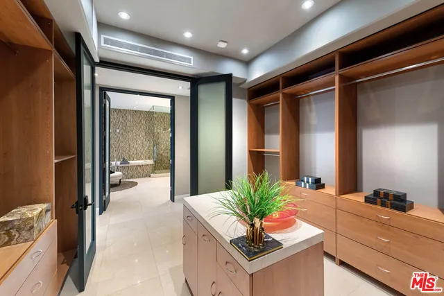 a bedroom with furniture and a chandelier