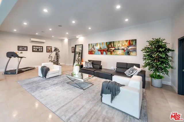 a front view of a house with swimming pool having outdoor seating